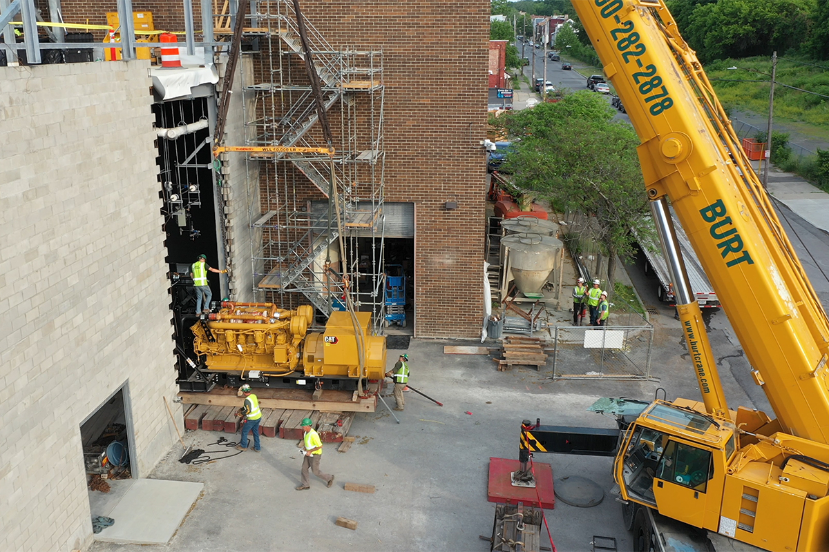 Bette & Cring Construction Group inserting a back-up generator utilizing a crane.