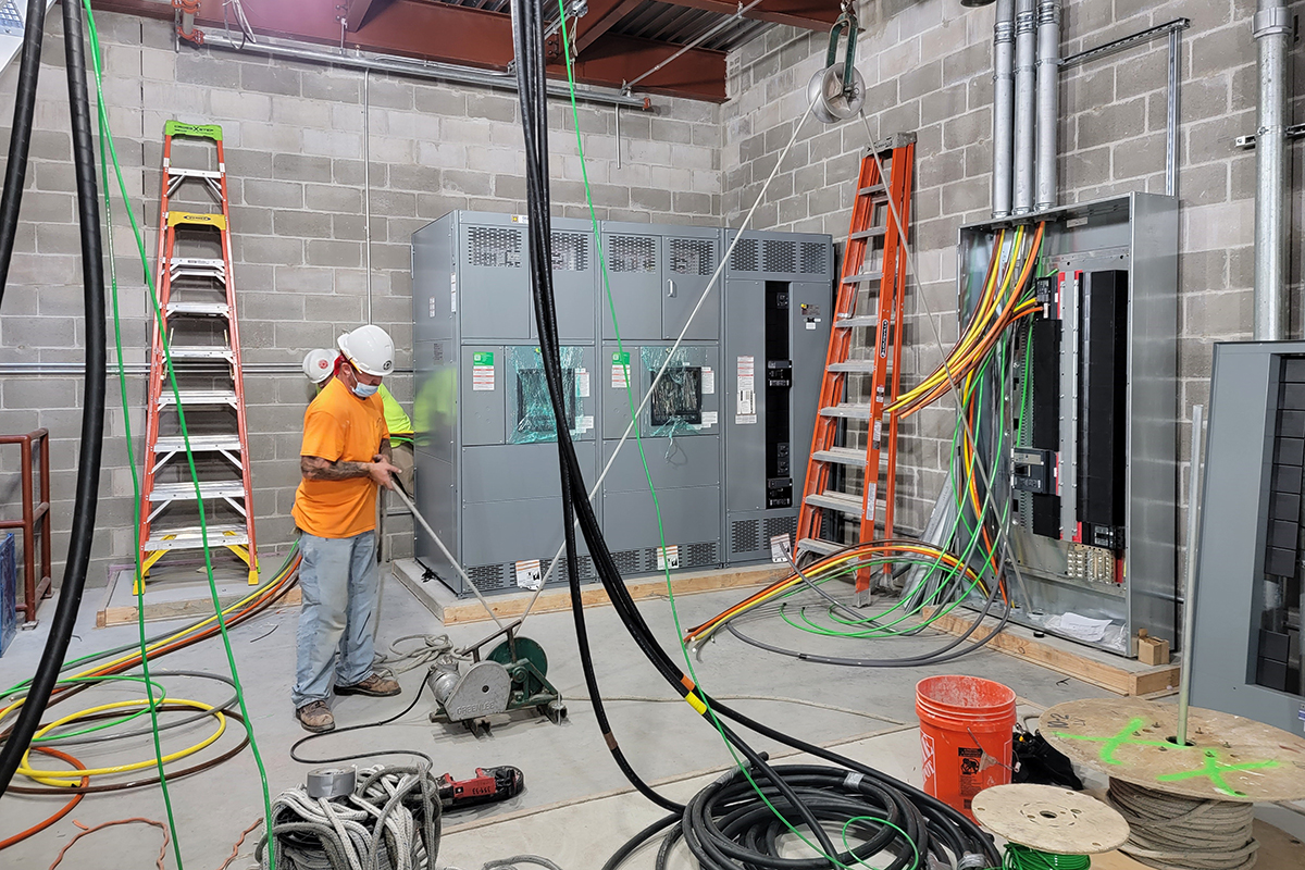 Technician installing electrical supply lines