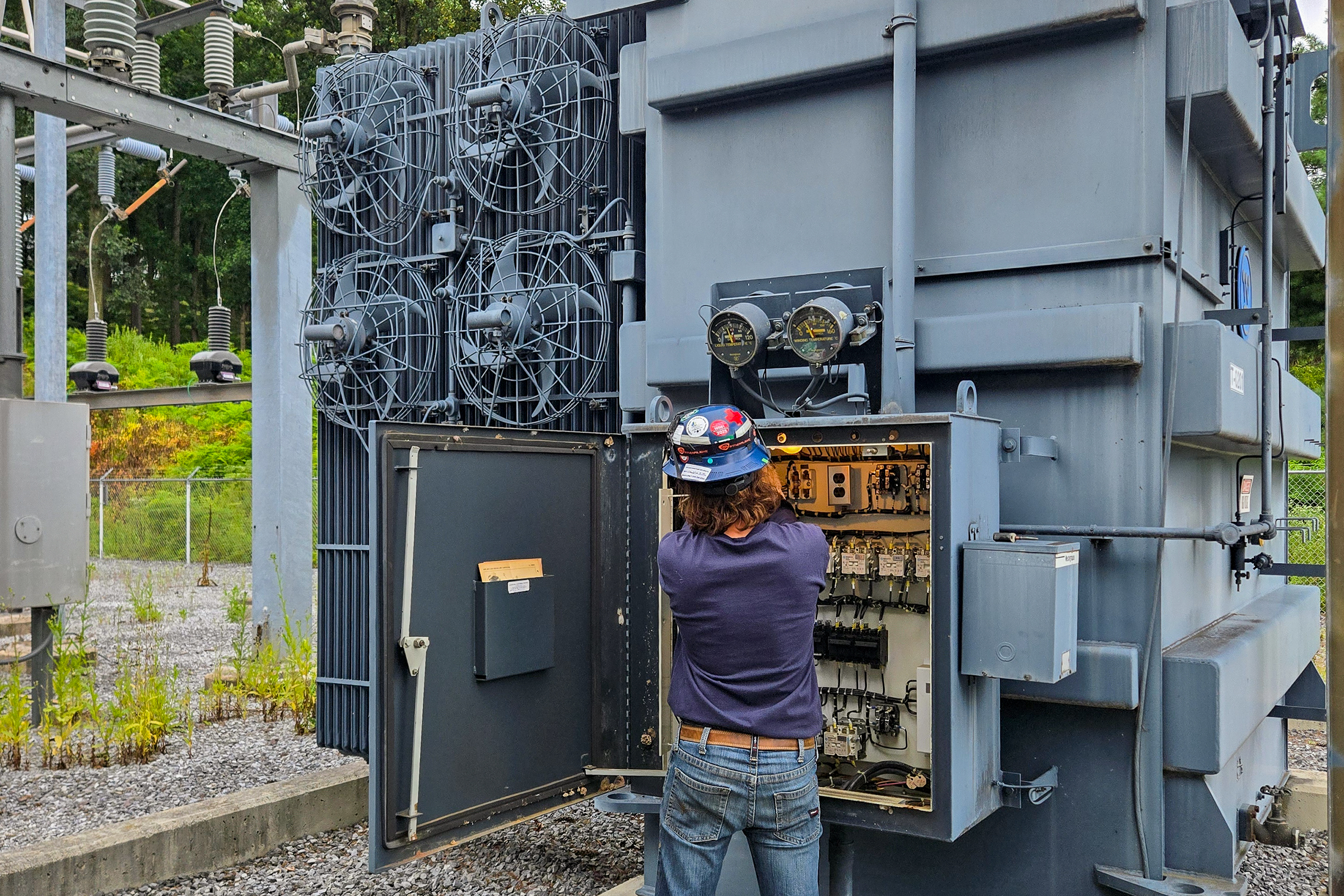 Electrical technician installing a direct transfer trip scheme into a hospital's substation.