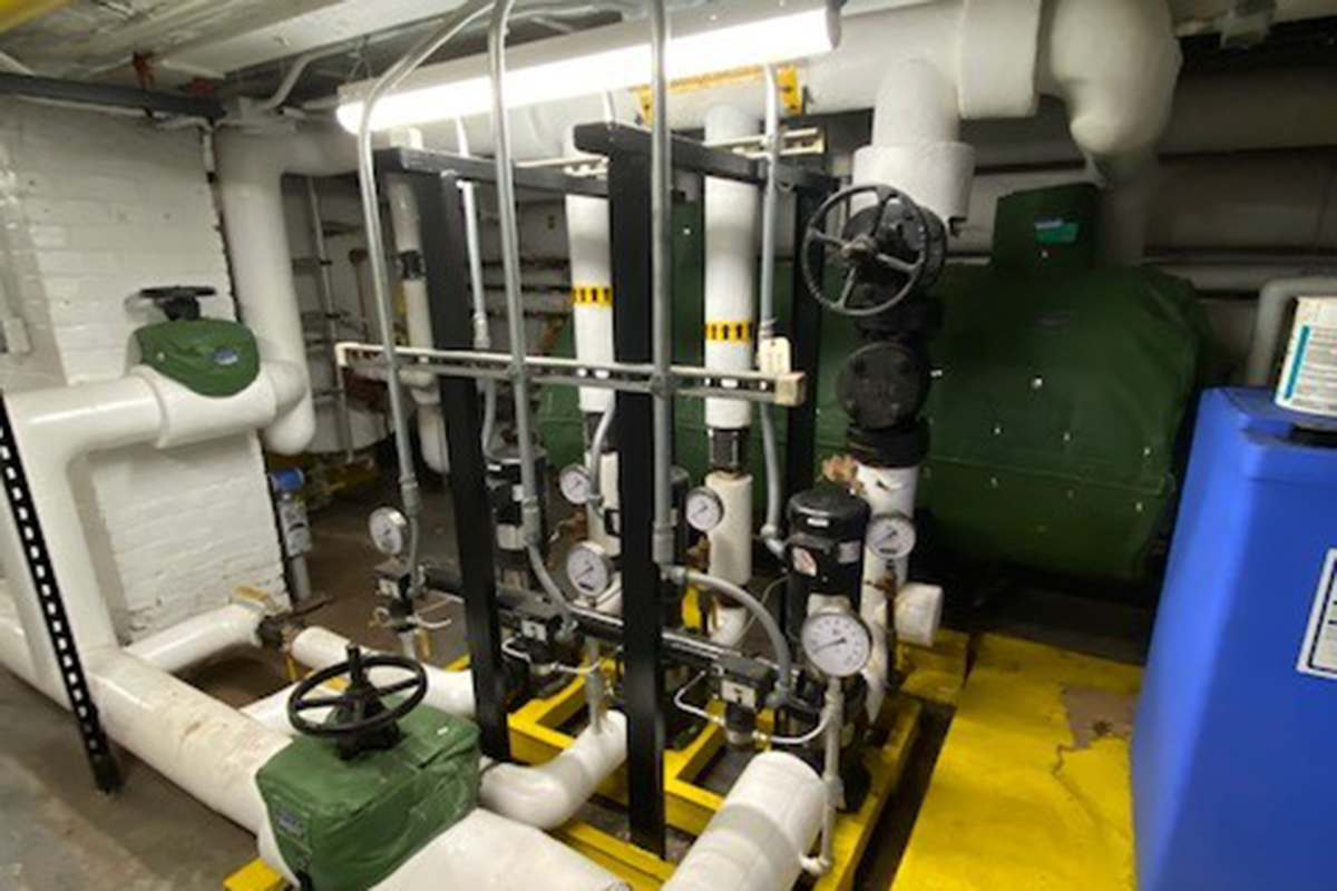 WPI's boiler room with white pipes and pressure gages.